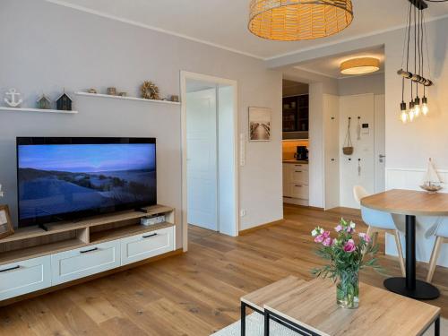 a living room with a large flat screen tv at Ferienwohnung Seeperle am Dümmer See in Lembruch