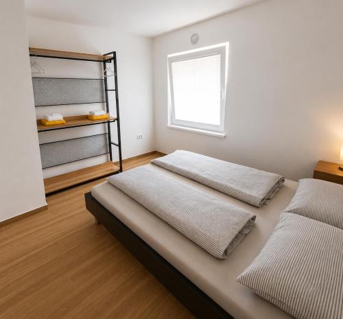 a bedroom with two beds and a window at Apartma 47 in Kobarid