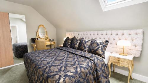 a bedroom with a large bed and a mirror at Bellinter House Hotel & Spa in Navan