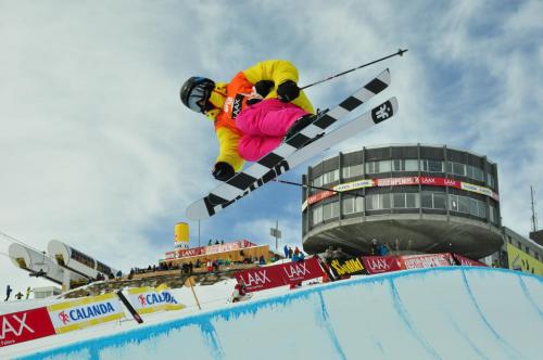 a man flying through the air while riding skis at Casa al Lag - direkt am Laaxersee in Laax