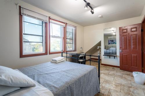 a bedroom with a bed and a desk in it at One Bus Stop to Time Square-4BR Duplex-Free Parking in Hillside