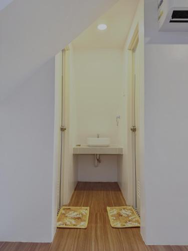 a bathroom with a sink and a mirror at Balay @ Santa Fe, Bantayan in Pooc