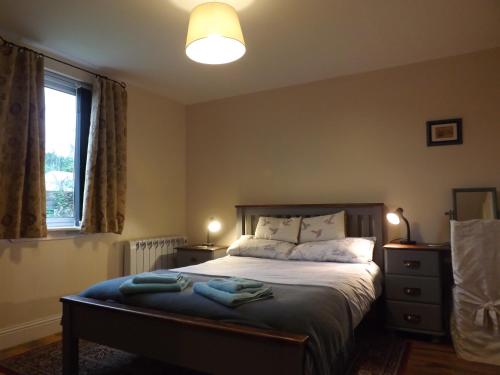 a bedroom with a bed and a window at Small cosy bothy in Dingwall