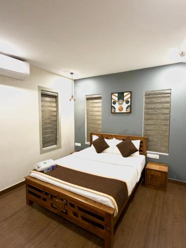 a bedroom with a large bed in a room at Wayanad Way Resort in Koroth