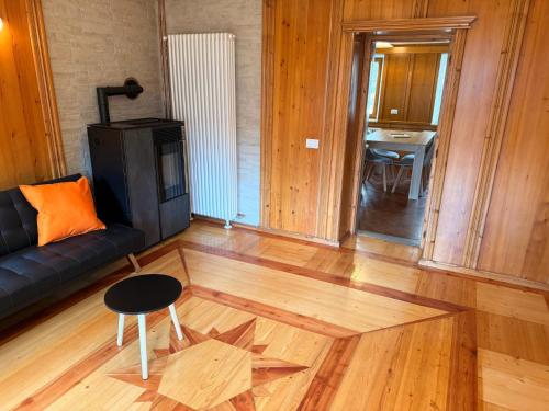 a living room with a couch and a table at Appartamento Girasole - Cadore Apartments in Candide
