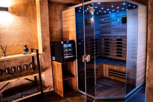 a shower with a glass door in a room at Wellness Chalupa U Juráša in Horní Bečva