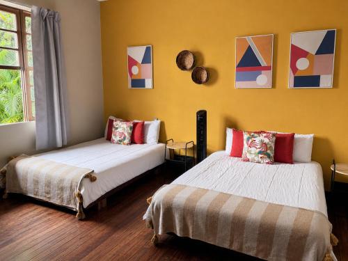 a bedroom with two beds and a window at awā San José in San José