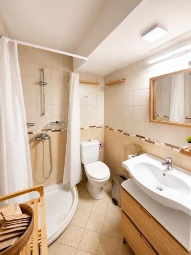 a bathroom with a sink and a toilet and a tub at Downtown View Apartment - Rhodes in Rhodes Town