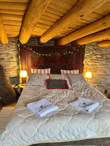 a large bed in a room with wooden ceilings at Casa cu Suflet in Sighişoara