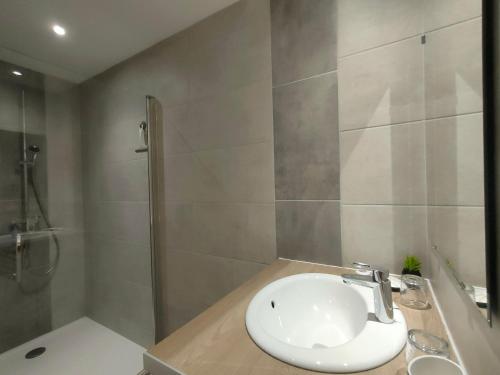 a bathroom with a sink and a shower at Locaplage in Lanton