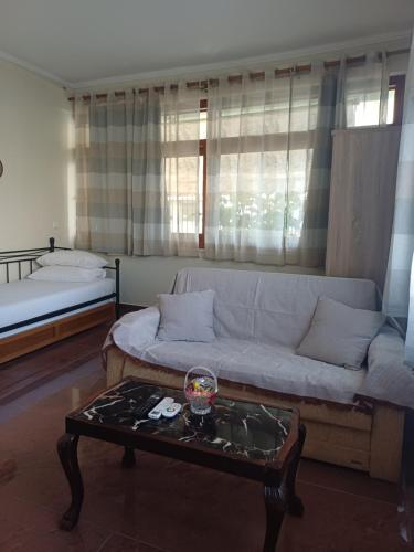 a living room with a couch and a coffee table at LA.KI House in Kavála