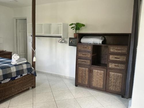 a bedroom with a bed and a dresser at HUMMINGBIRD Hotel Cabarete in Cabarete