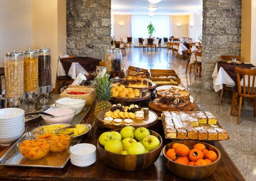 a buffet with many different types of food on a table at Hotel Bleis in Ponte di Legno