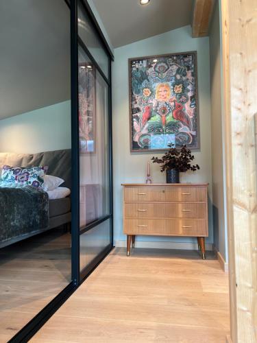 a room with a mirror and a dresser and a bed at The Dream Factory in Andøya