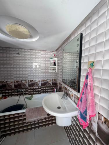 a bathroom with a sink and a bath tub at Lemjid house in Kelibia