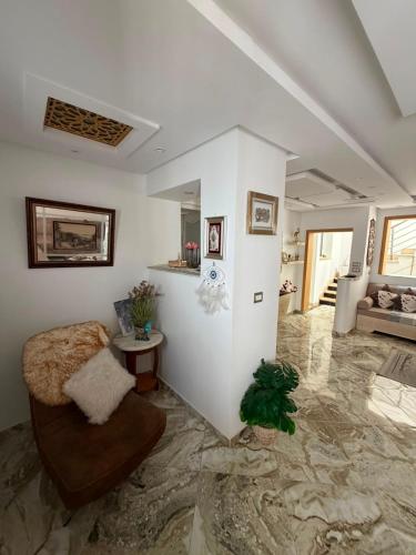 a living room with a couch and a chair at Lemjid house in Kelibia