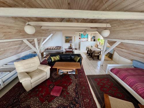 a living room with a couch and a table at Hostel Agger Vandrerhjem in Agger