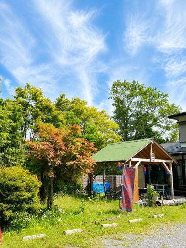 a building with a gazebo in a yard at STAY FUJI a in Yamanakako
