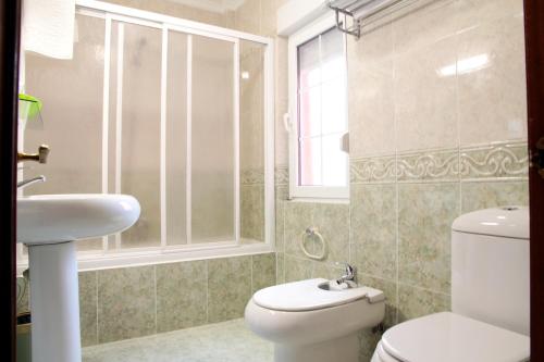 a bathroom with a toilet and a sink at La Calma Candás in Candás