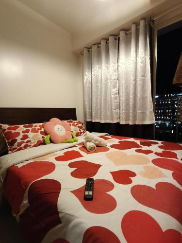 a bedroom with a bed with a remote control on it at Shore residences tower D in Manila