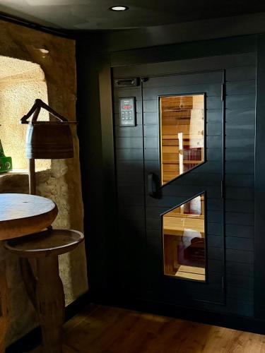 a black door in a room with a wooden stool at Fagundes Village in Valença