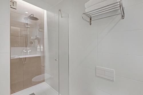 a bathroom with a shower with a glass door at B&B HOTEL Murcia Thader in Churra