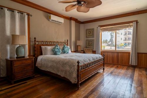 a bedroom with a bed and a ceiling fan at Oceans 23 in San Pedro Island