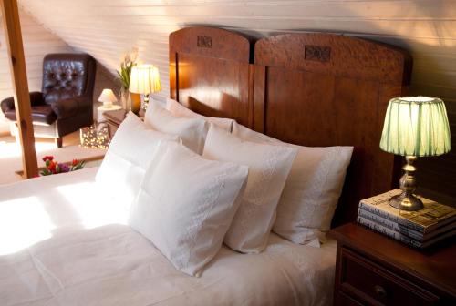 a bedroom with a large bed with white pillows at Adami Country Guesthouse in Vainupea
