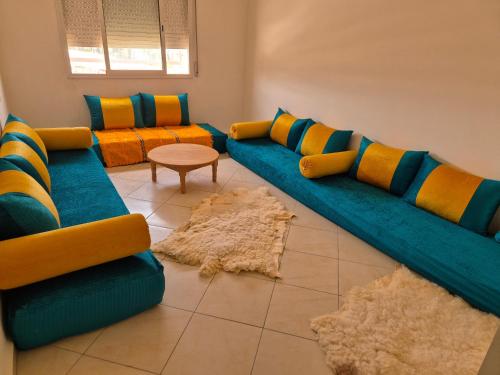 a living room with a couch and two chairs and a table at Zohor atlas in Beni Mellal