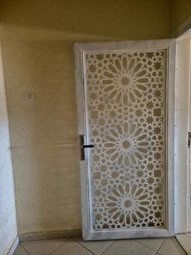 a metal door with a flower pattern on it at Zohor atlas in Beni Mellal