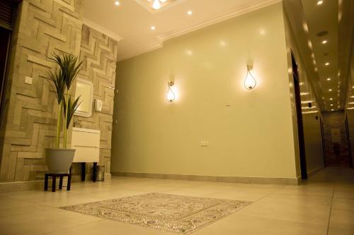 a hallway with two lights and a potted plant at Velvet Suites in Kigali