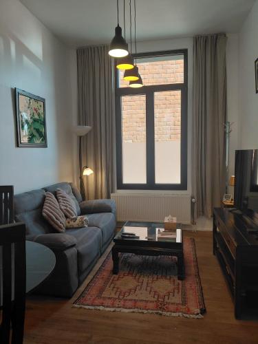 a living room with a couch and a coffee table at Logies De Lelie in Antwerp