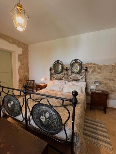 a bedroom with a bed with a wrought iron frame at Casa del boscaiolo in Trevi