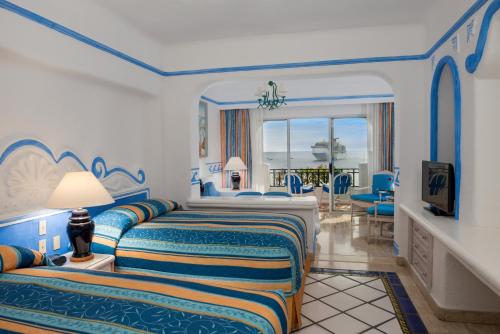 a hotel room with two beds and a balcony at Pueblo Bonito Los Cabos Blanco Beach Resort - All Inclusive in Cabo San Lucas