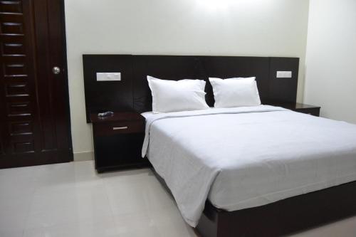 Ένα ή περισσότερα κρεβάτια σε δωμάτιο στο Hotel Sea Uttara