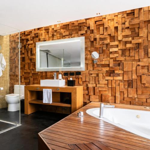 a bathroom with a tub and a sink and a mirror at Casa Caballero y Osio in Querétaro