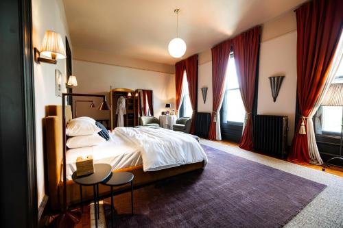 a hotel room with a bed and a table and chairs at The Truitt in Saint Louis