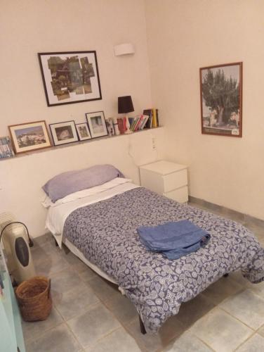 a bedroom with a bed with a blue blanket at Casaroc in Sella