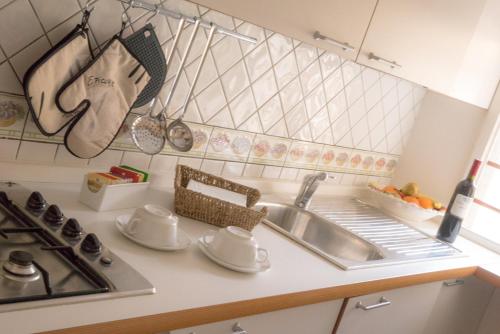 a kitchen counter with a sink and a stove at Casa Dalia rifugio romantico in Montecatini Terme