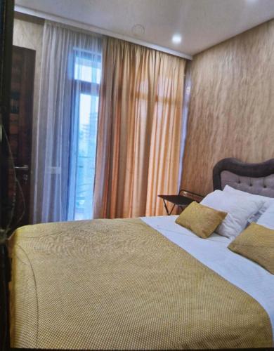 a bedroom with a large bed and a window at Archil in Batumi International Airport