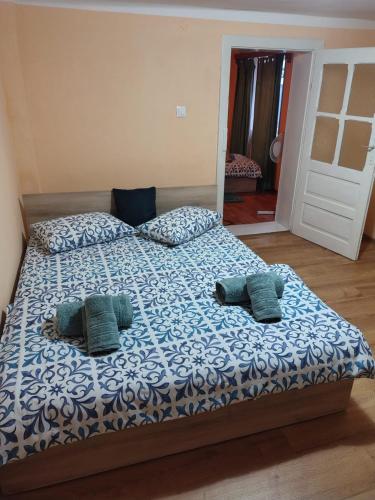 a bed with two pillows on it in a bedroom at Casa La Bunica in Orşova