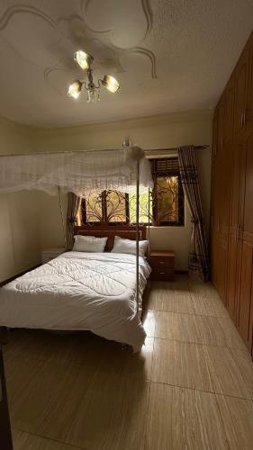 a bedroom with a white bed with a canopy at Lorycon 