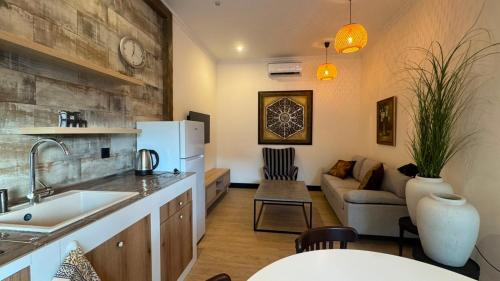 a kitchen with a sink and a living room at Burada in Baku