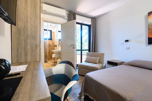 a bedroom with a bed and a desk and a chair at Hotel Anna in Siena