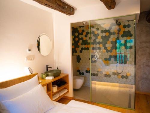 a bathroom with a glass shower with a toilet at Posestvo Pri žabi in Štanjel