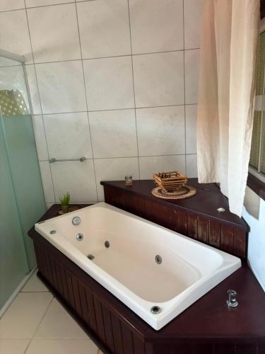 a bath tub in a bathroom with a shower at Casa do Professor Hostel in Barreirinhas