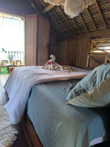 a bed with a stuffed animal on top of it at Erina Beach in Antalaha