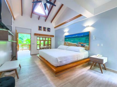 a bedroom with a bed and a large painting on the wall at Casa Las Palmas in San Andrés