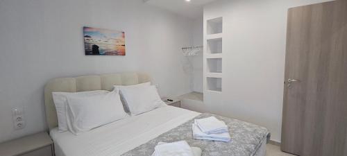 a bedroom with a bed with two towels on it at Alexandras Maisonette in Skiathos