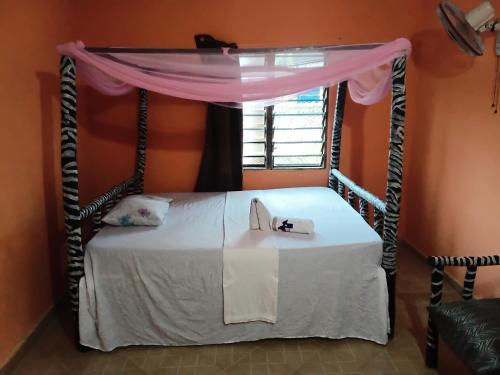 a bedroom with a canopy bed in a room at Bububu creek house in Mombasa
